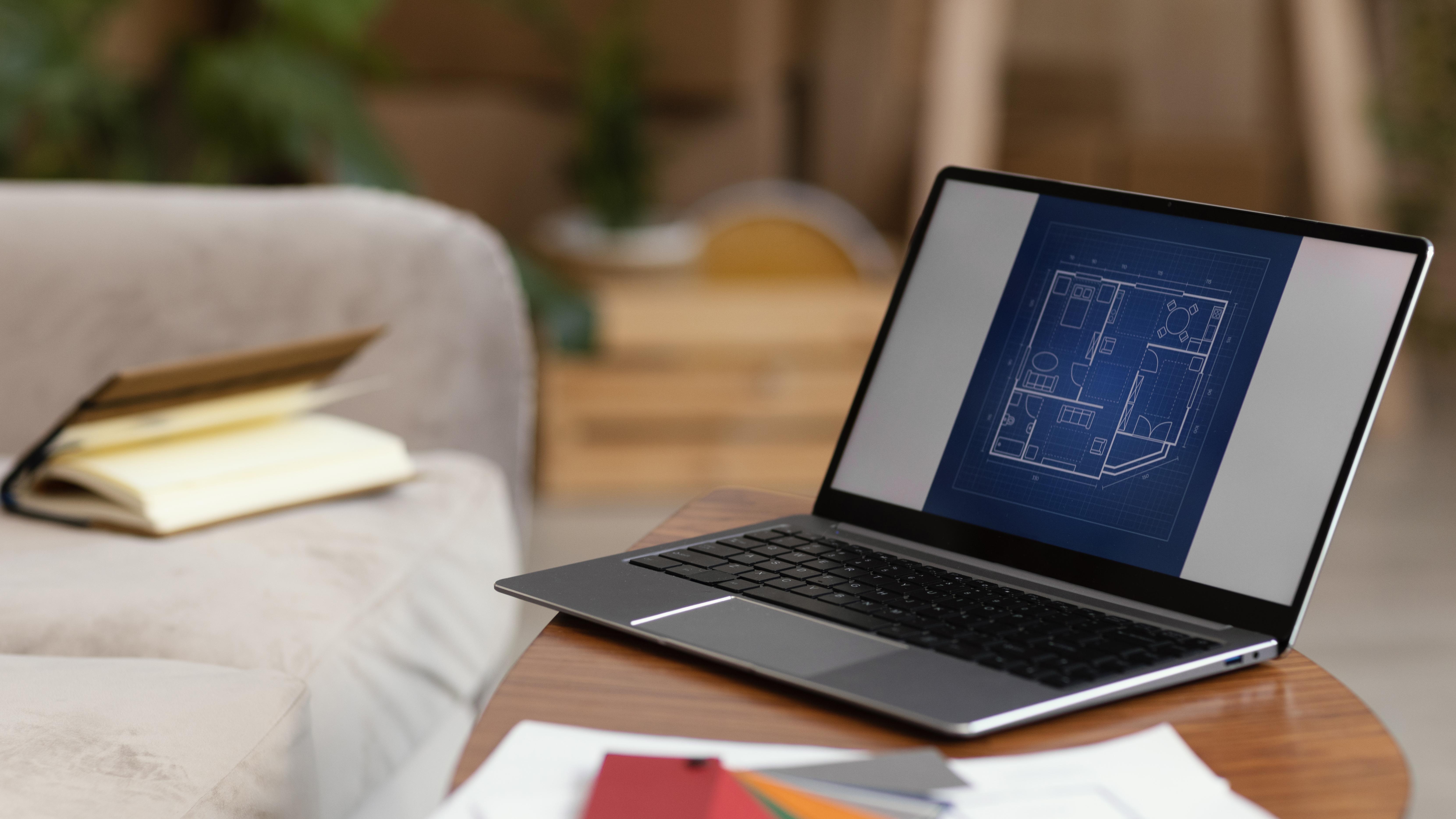 Book a free site visit - Laptop with blueprints